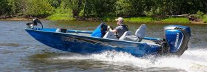 Male Angler Drives Blue Pro 185 Bass Boat on River